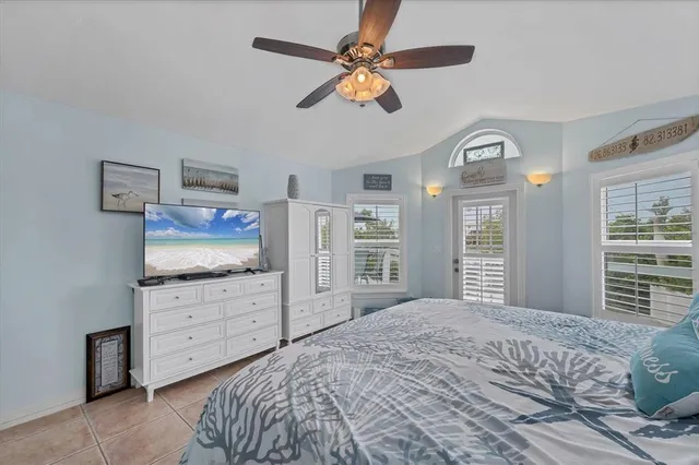 a bedroom with a bed cabinets and a window