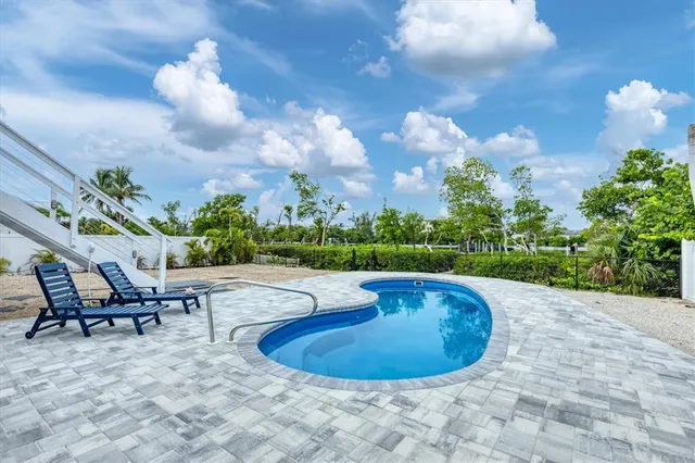 a view of a swimming pool with sitting area