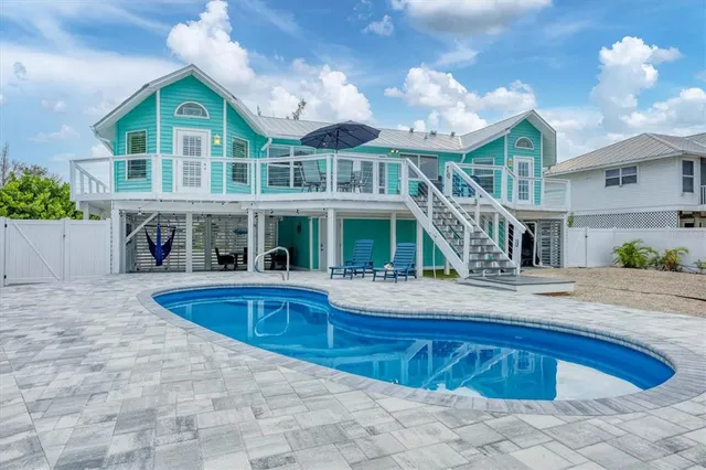 a view of a house with swimming pool and porch