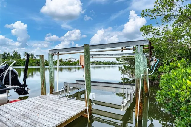a view of balcony with two chairs and potted plants