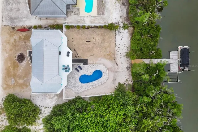 an aerial view of a house with outdoor space