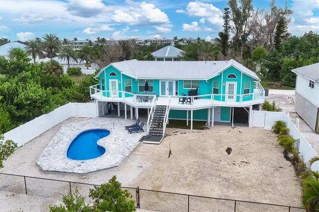 an aerial view of a house with yard patio and fire pit