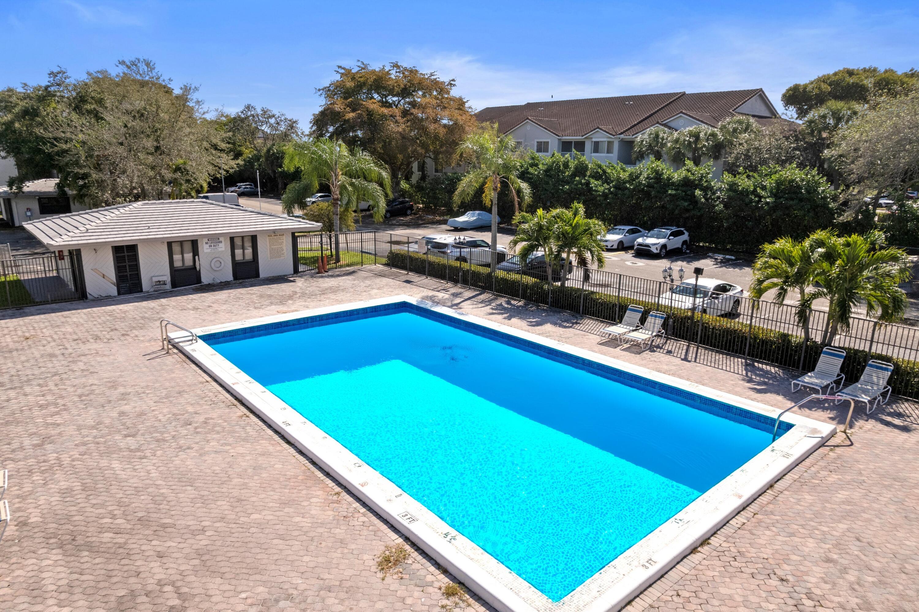 3710 North Pine Island Road, Unit 114 Sunrise, FL 33351 - Photo 18 of 32 a view of a pool with a patio