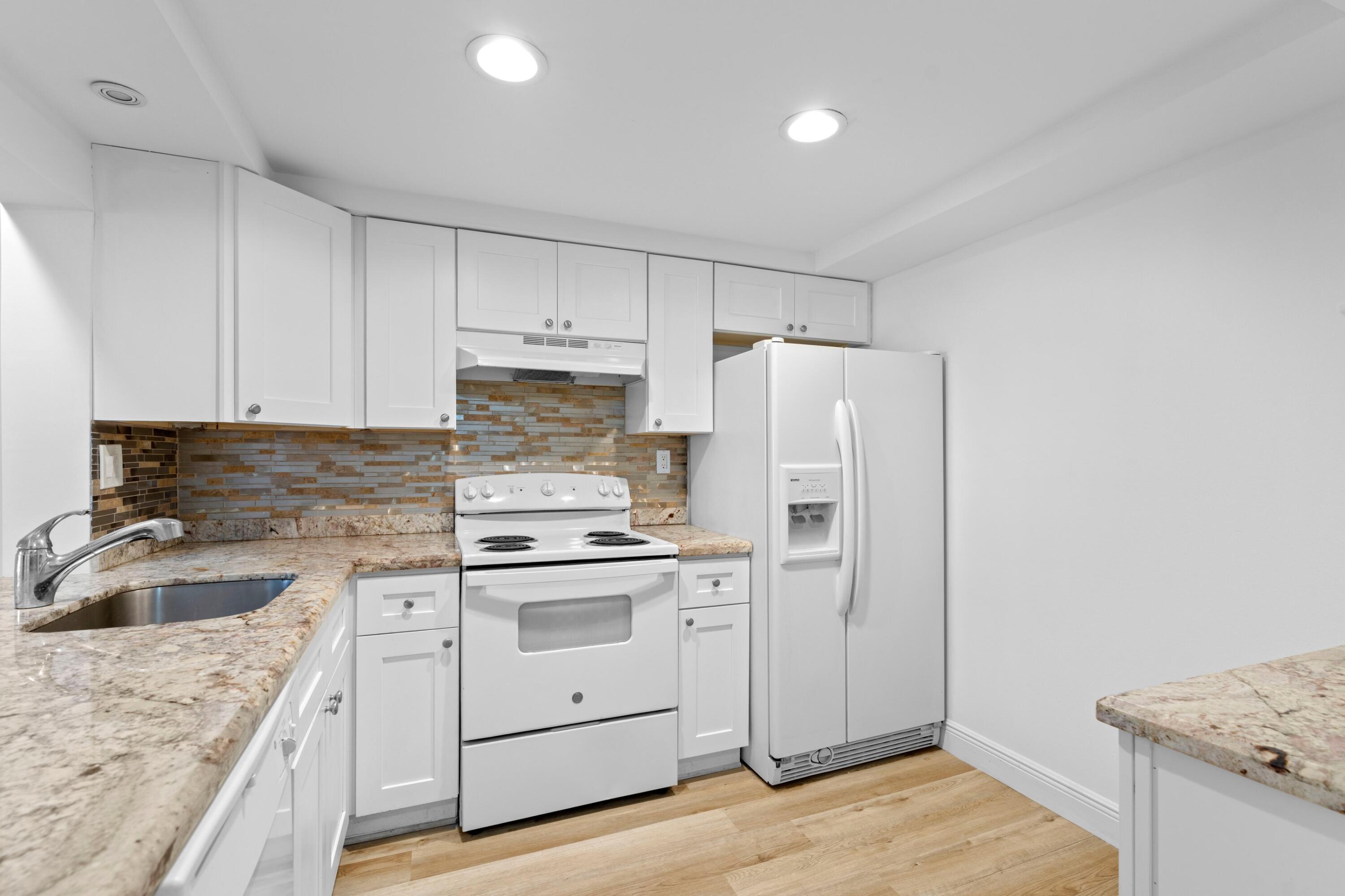 3710 North Pine Island Road, Unit 114 Sunrise, FL 33351 - Photo 9 of 32 a kitchen with a stove a sink and a refrigerator