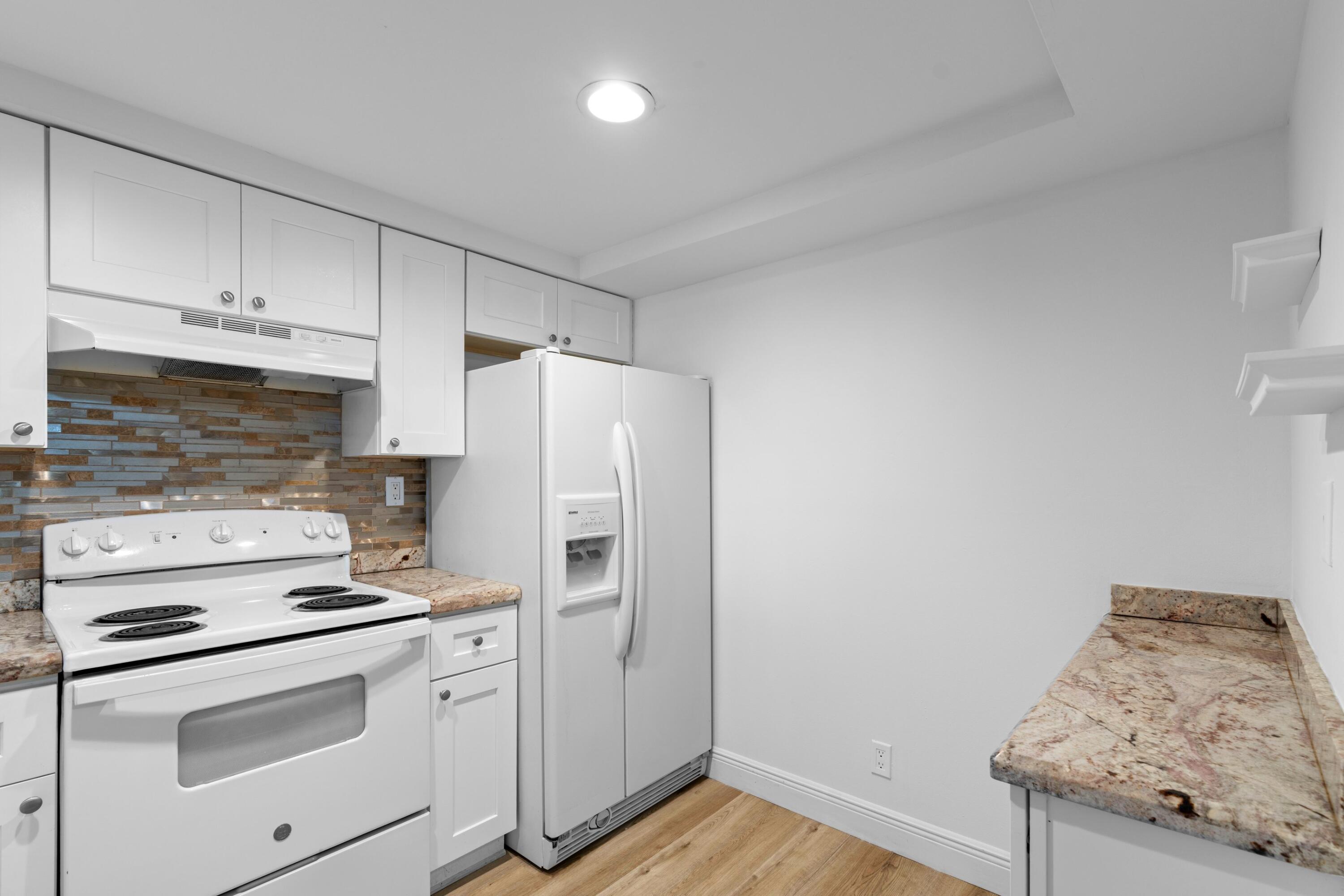 3710 North Pine Island Road, Unit 114 Sunrise, FL 33351 - Photo 10 of 32 a kitchen with a stove cabinets and refrigerator