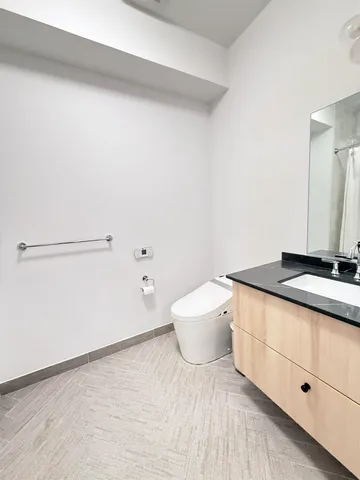 a view of a room with wooden floor and cabinet
