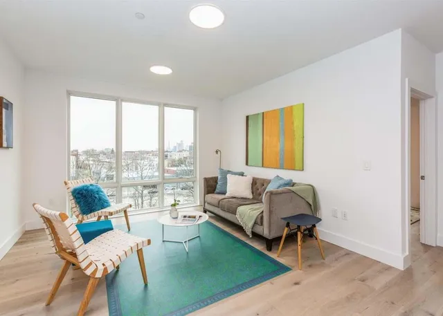a living room with furniture and a large window
