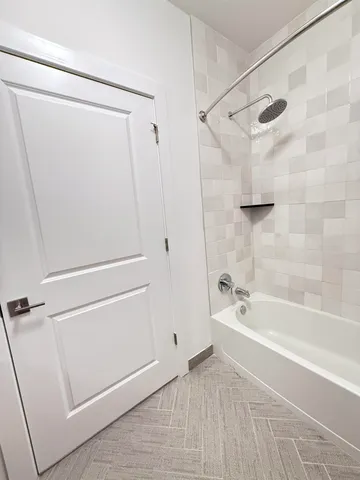a bathroom with a bathtub and a shower