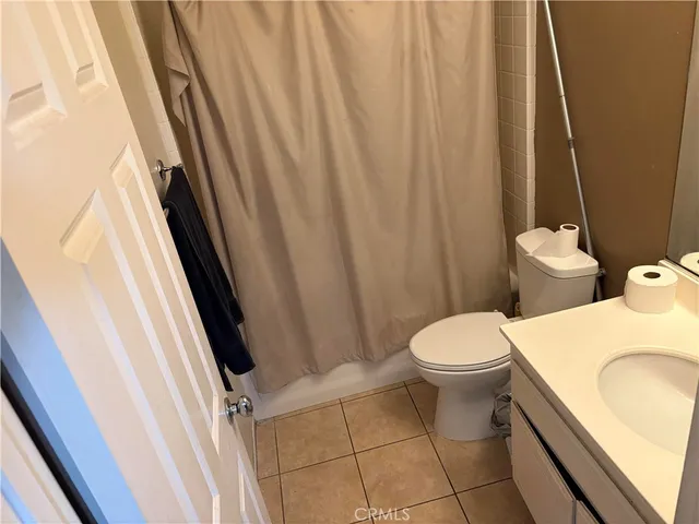a white toilet sitting next to a sink