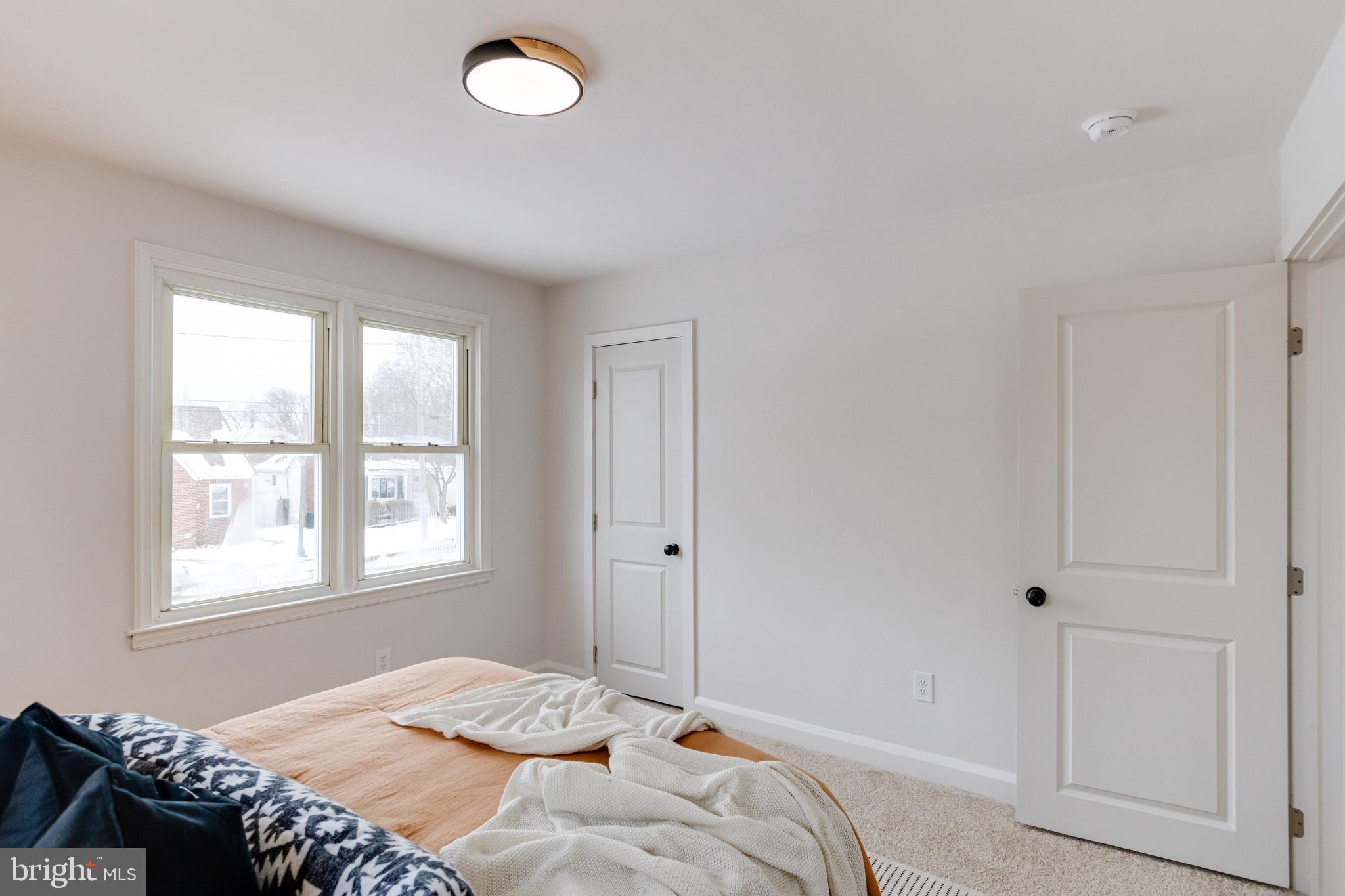 7606 Bagley Avenue Baltimore, MD 21234 - Photo 16 of 45 a bedroom with a bed and a window