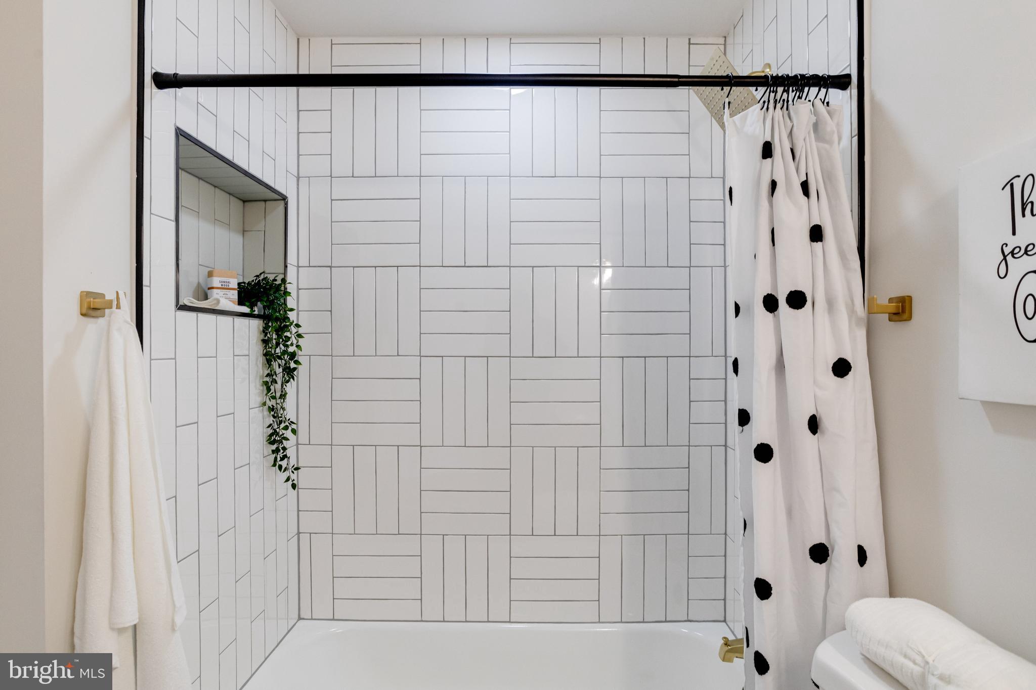 7606 Bagley Avenue Baltimore, MD 21234 - Photo 18 of 45 a bathroom with a shower and a toilet