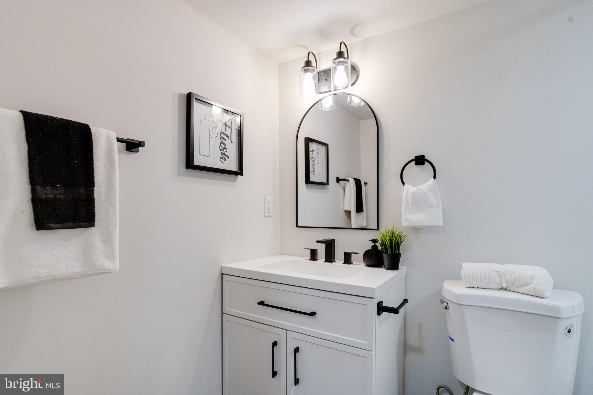 7606 Bagley Avenue Baltimore, MD 21234 - Photo 38 of 45 a bathroom with a sink mirror and toilet