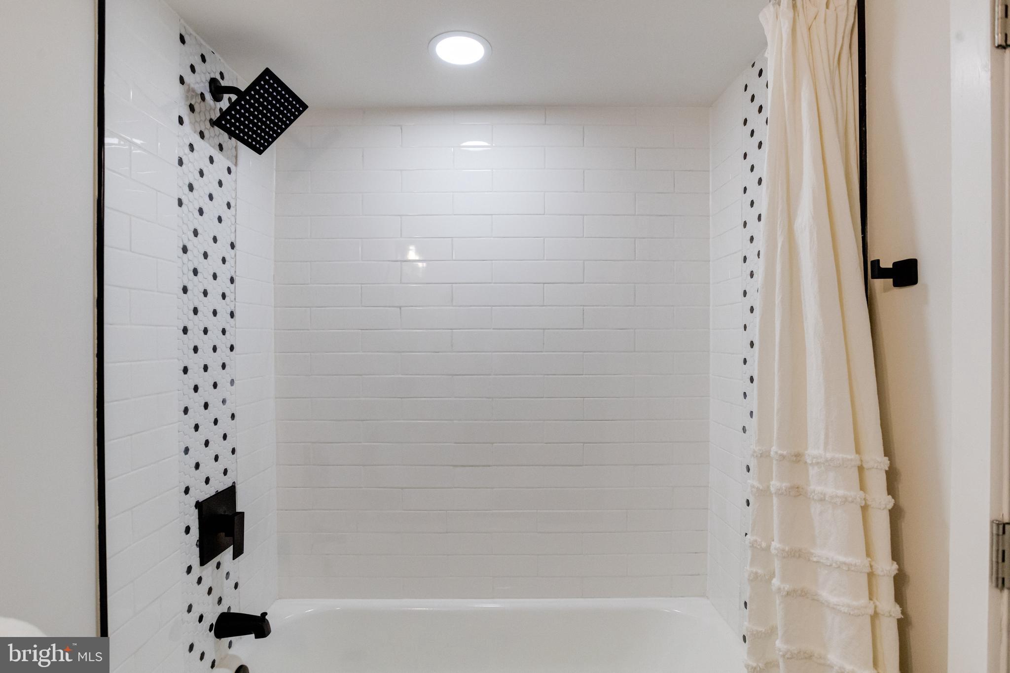 7606 Bagley Avenue Baltimore, MD 21234 - Photo 39 of 45 a bathroom with bathtub and shower