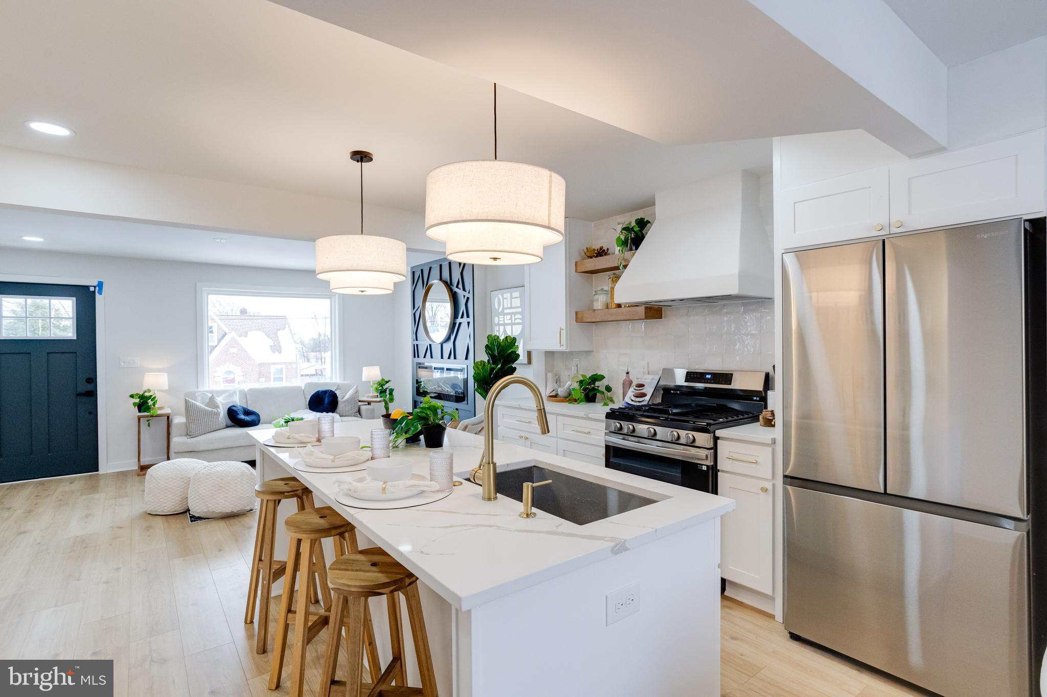 7606 Bagley Avenue Baltimore, MD 21234 - Photo 10 of 45 a kitchen with stainless steel appliances a stove a sink a refrigerator a center island a stove and white cabinets