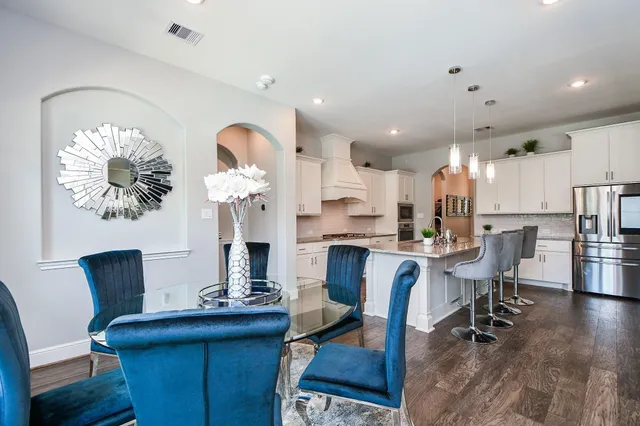 a living room with furniture and kitchen view