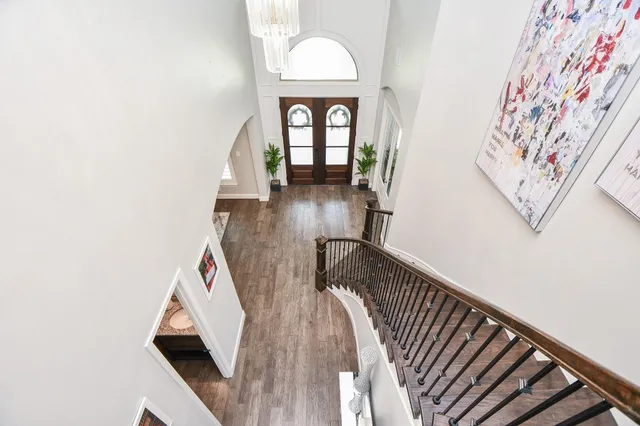 a view of a hallway with wooden floor and entryway