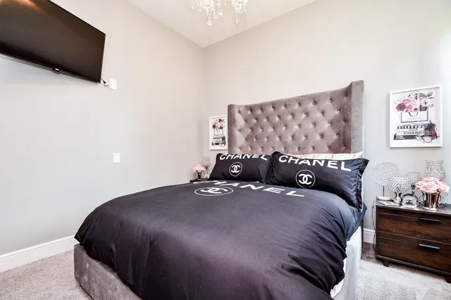 a bedroom with a bed and a flat screen tv