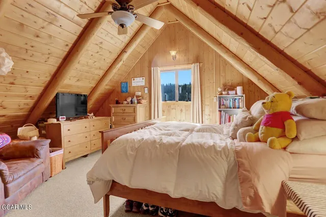 a bed room with a bed and a chair