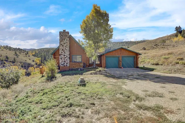 a backyard of a house with large trees