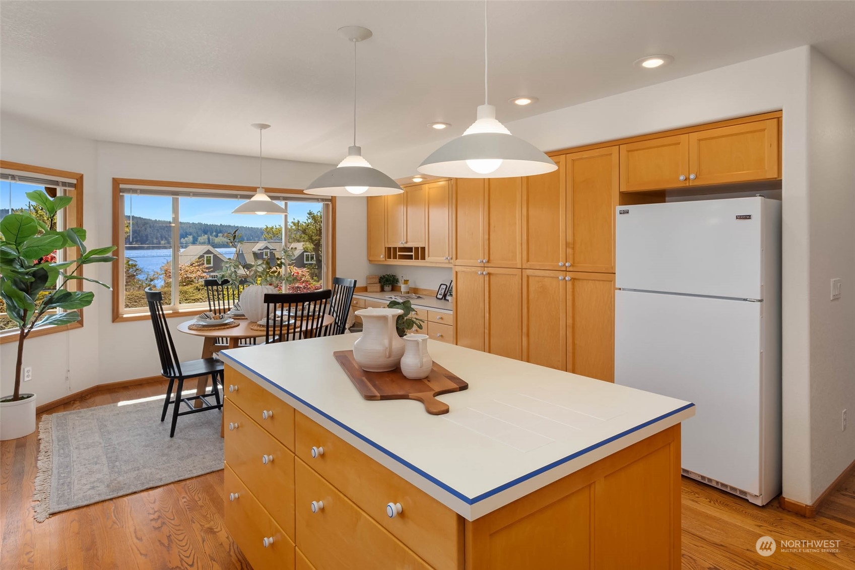 6404 Warren Street Anacortes, WA 98221 - Photo 14 of 38 a kitchen with a appliances a table and chairs in it
