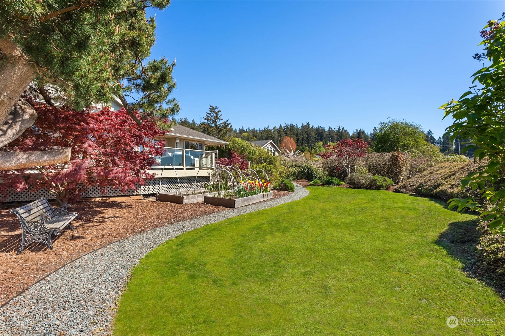 6404 Warren Street Anacortes, WA 98221 - Photo 31 of 38 a view of a patio with a table and chairs under an umbrella