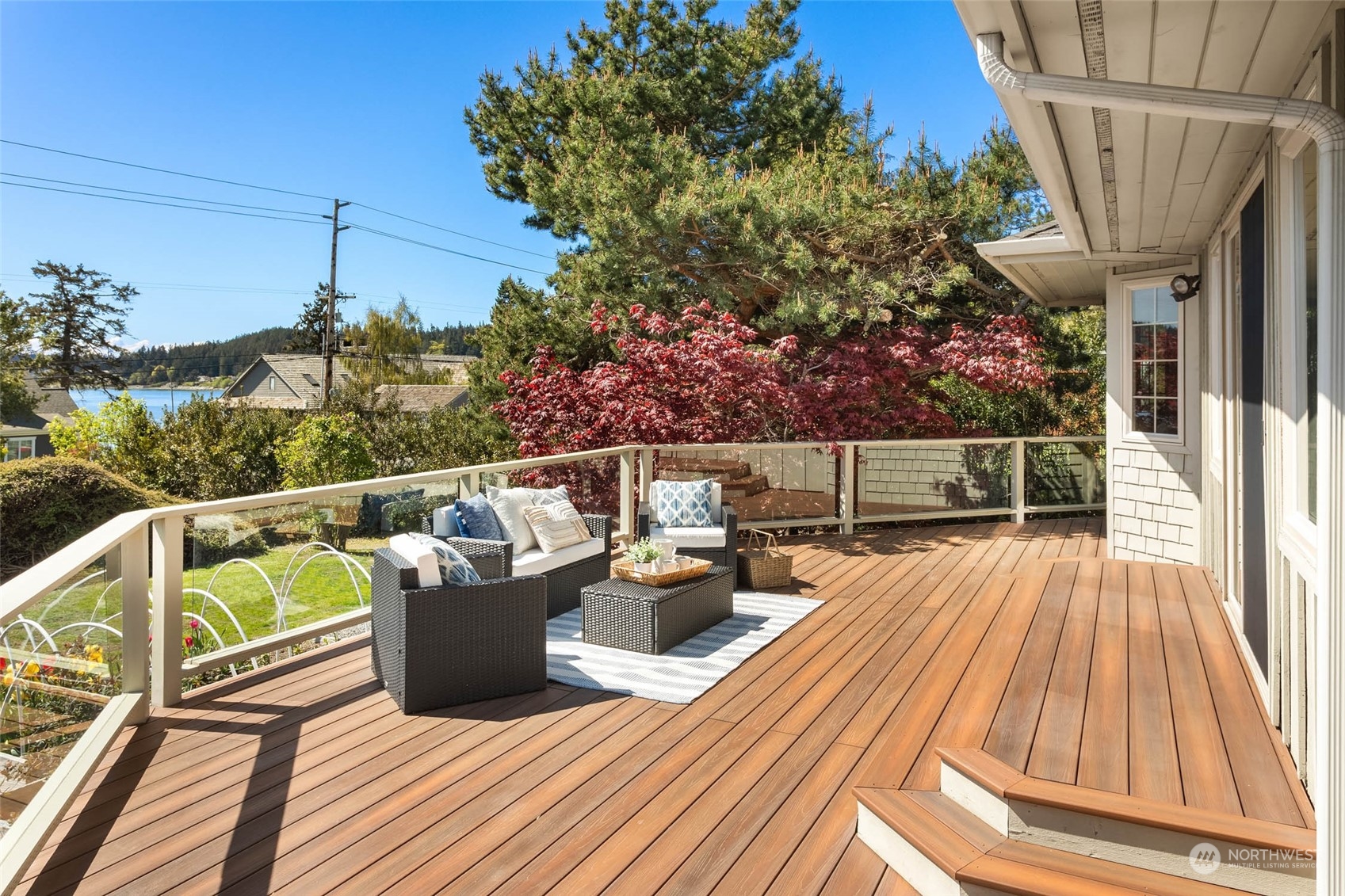 6404 Warren Street Anacortes, WA 98221 - Photo 33 of 38 a view of balcony with wooden floor and outdoor seating