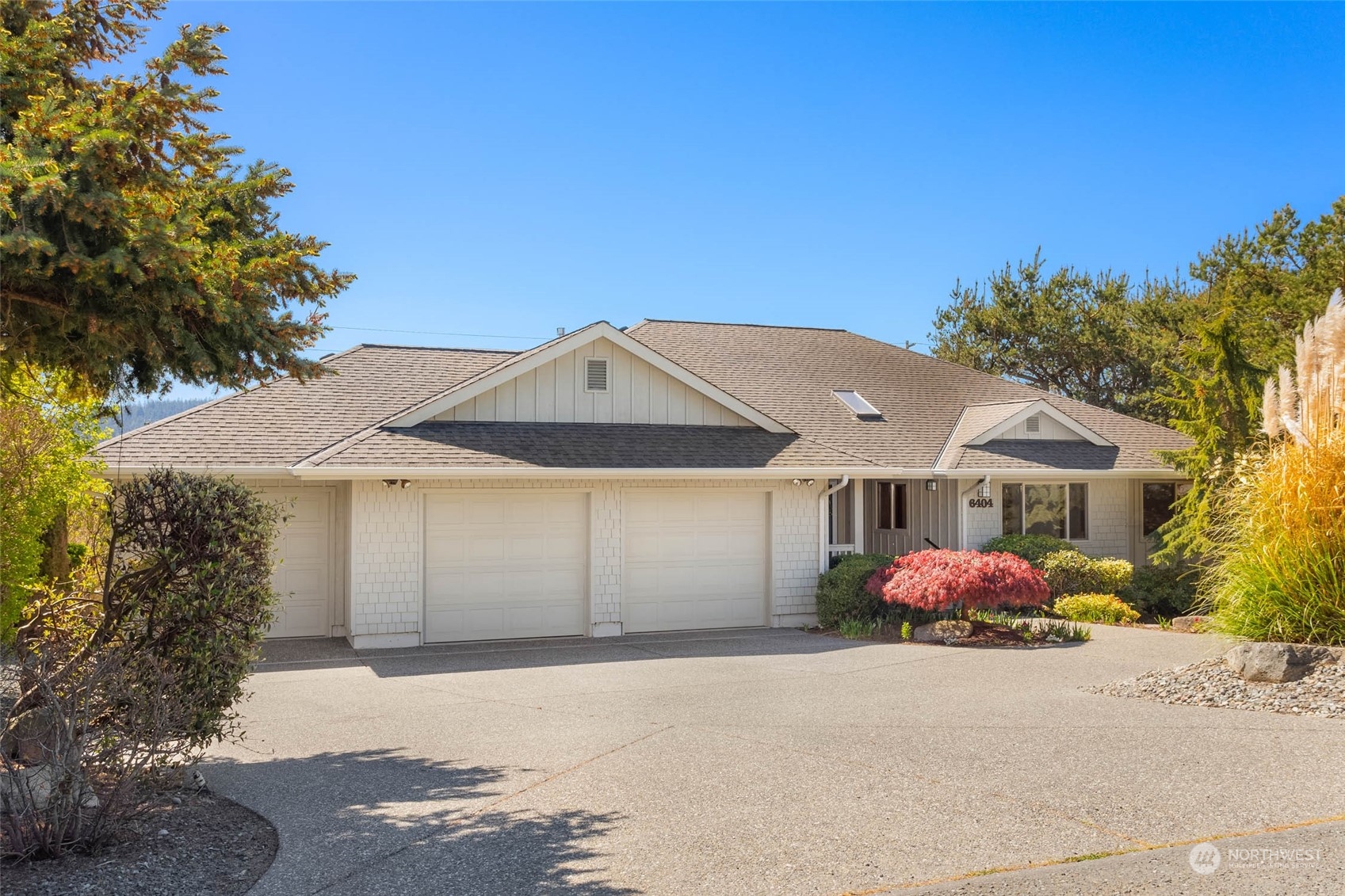 6404 Warren Street Anacortes, WA 98221 - Photo 5 of 38 a front view of a house with a yard and garage
