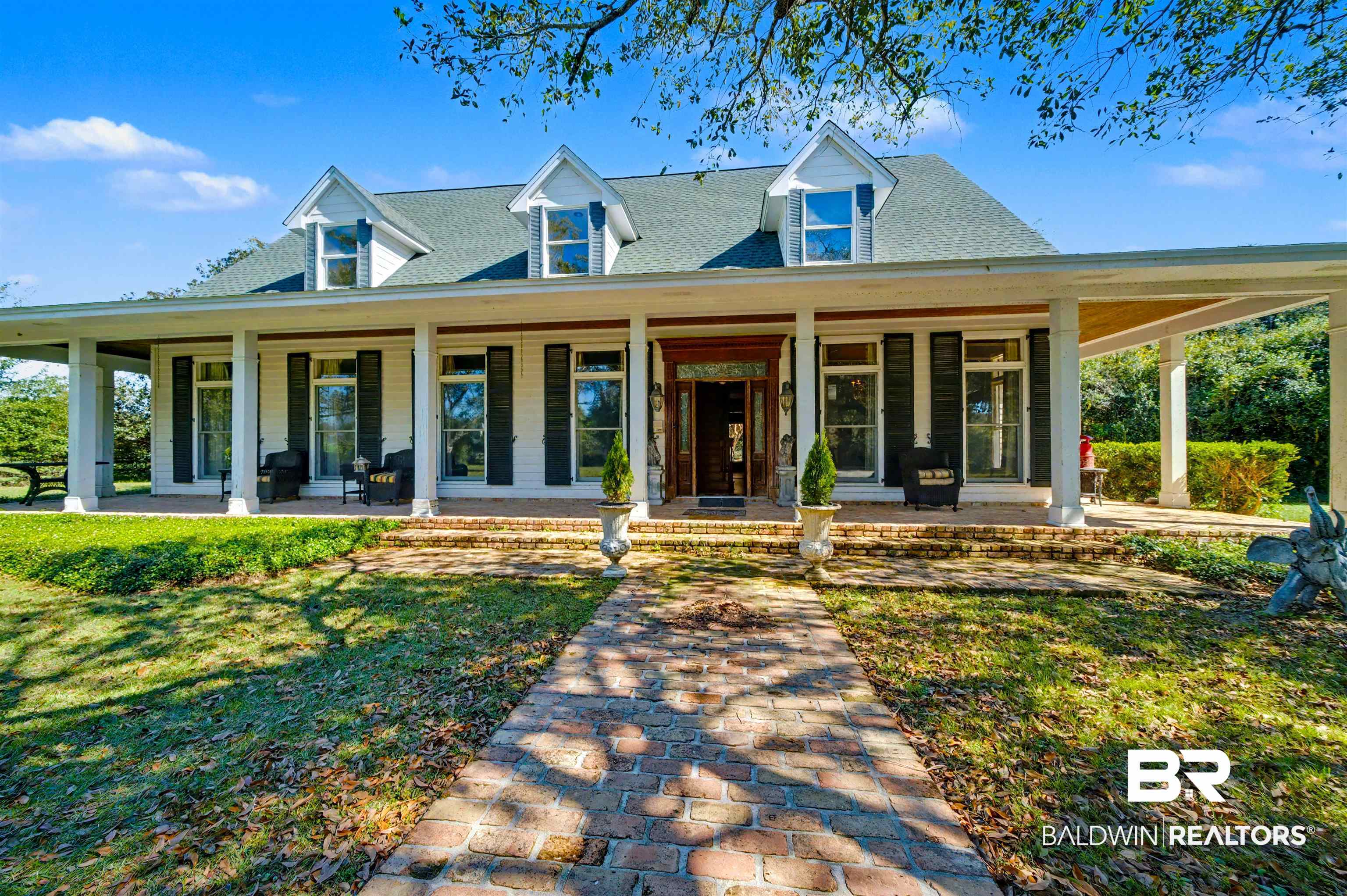 15810 County Road 73 Foley, AL 36535 - Photo 4 of 56 View of front of home with a porch, a front yard, and a shingled roof