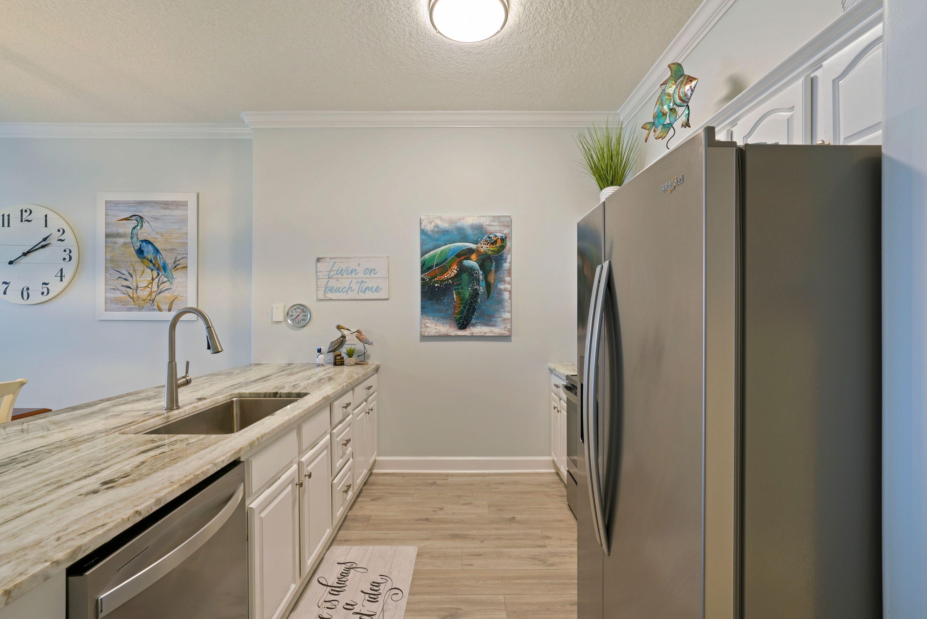 14415 Front Beach Road, Unit 2007 Panama City Beach, FL 32413 - Photo 10 of 26 a kitchen with stainless steel appliances granite countertop a refrigerator and a sink