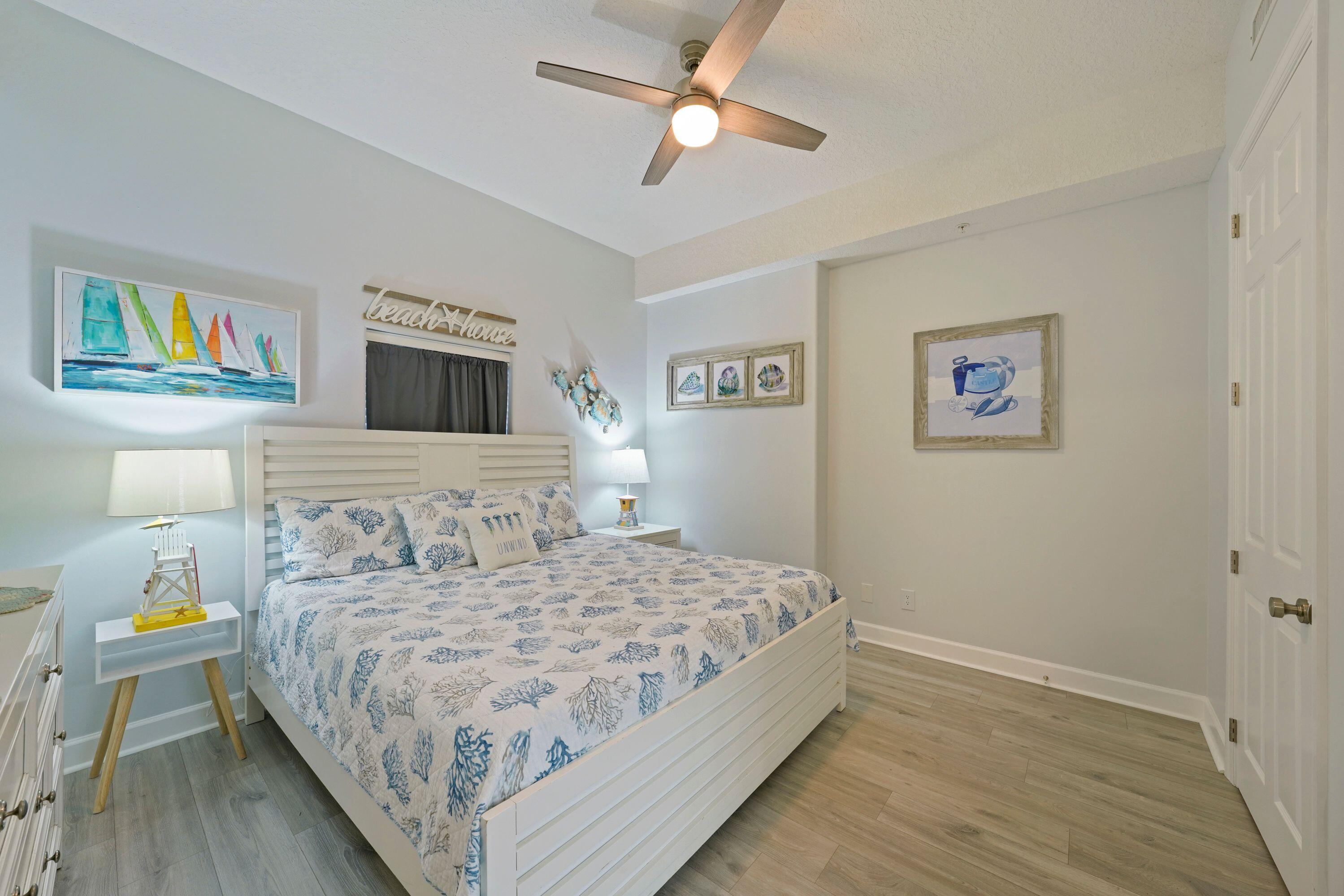14415 Front Beach Road, Unit 2007 Panama City Beach, FL 32413 - Photo 12 of 26 a bedroom with a bed and a chandelier