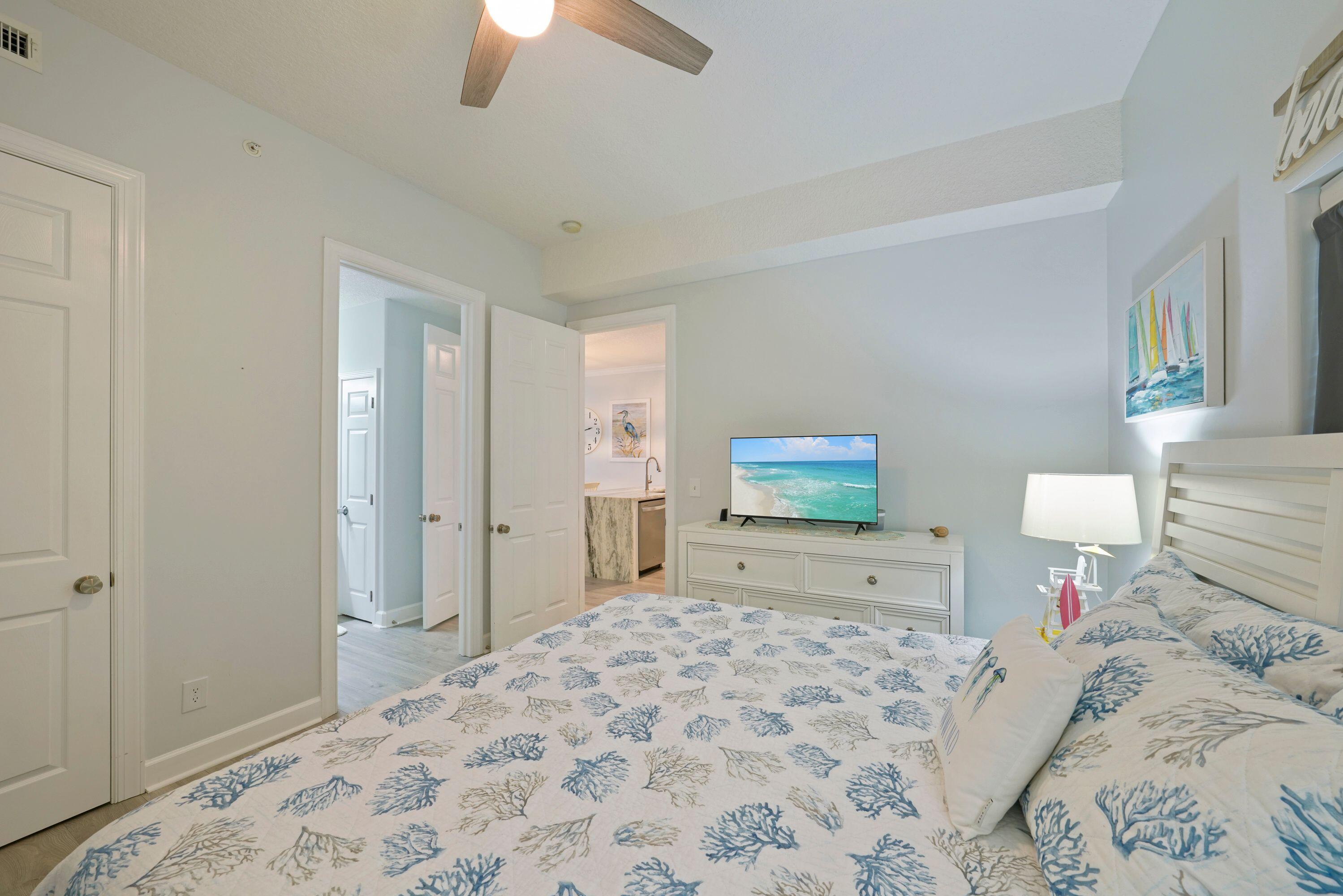 14415 Front Beach Road, Unit 2007 Panama City Beach, FL 32413 - Photo 14 of 26 a bedroom with a bed and a flat screen tv