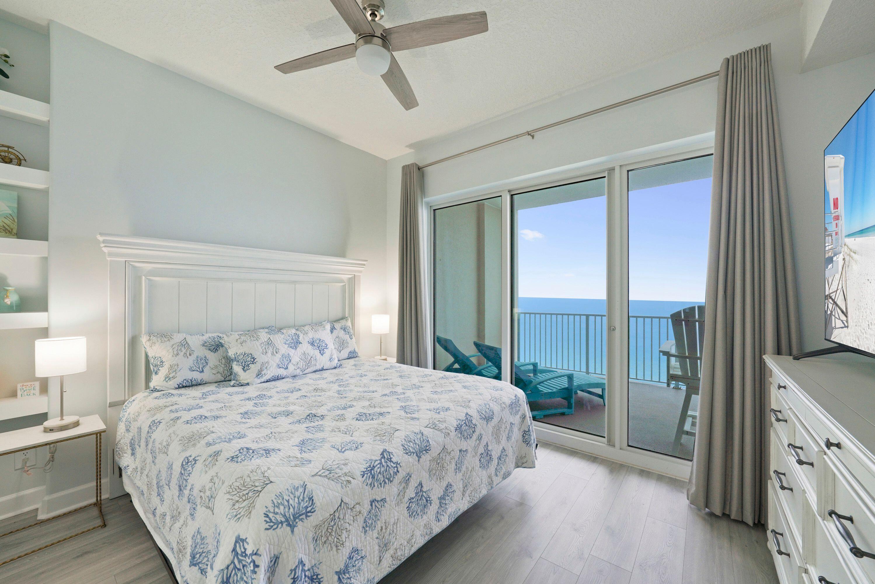 14415 Front Beach Road, Unit 2007 Panama City Beach, FL 32413 - Photo 17 of 26 a bedroom with a large bed and a flat tv screen on dresser
