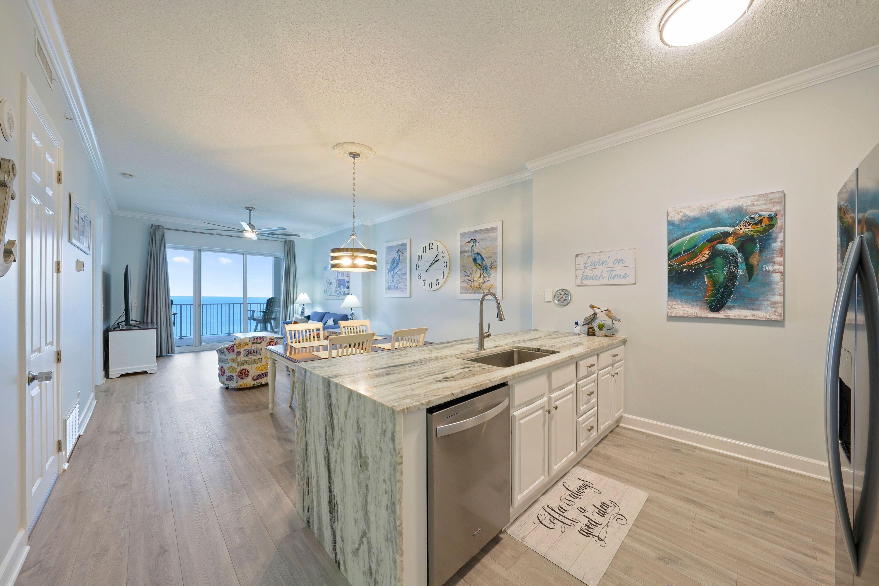 14415 Front Beach Road, Unit 2007 Panama City Beach, FL 32413 - Photo 8 of 26 a view of a kitchen area with furniture and wooden floor