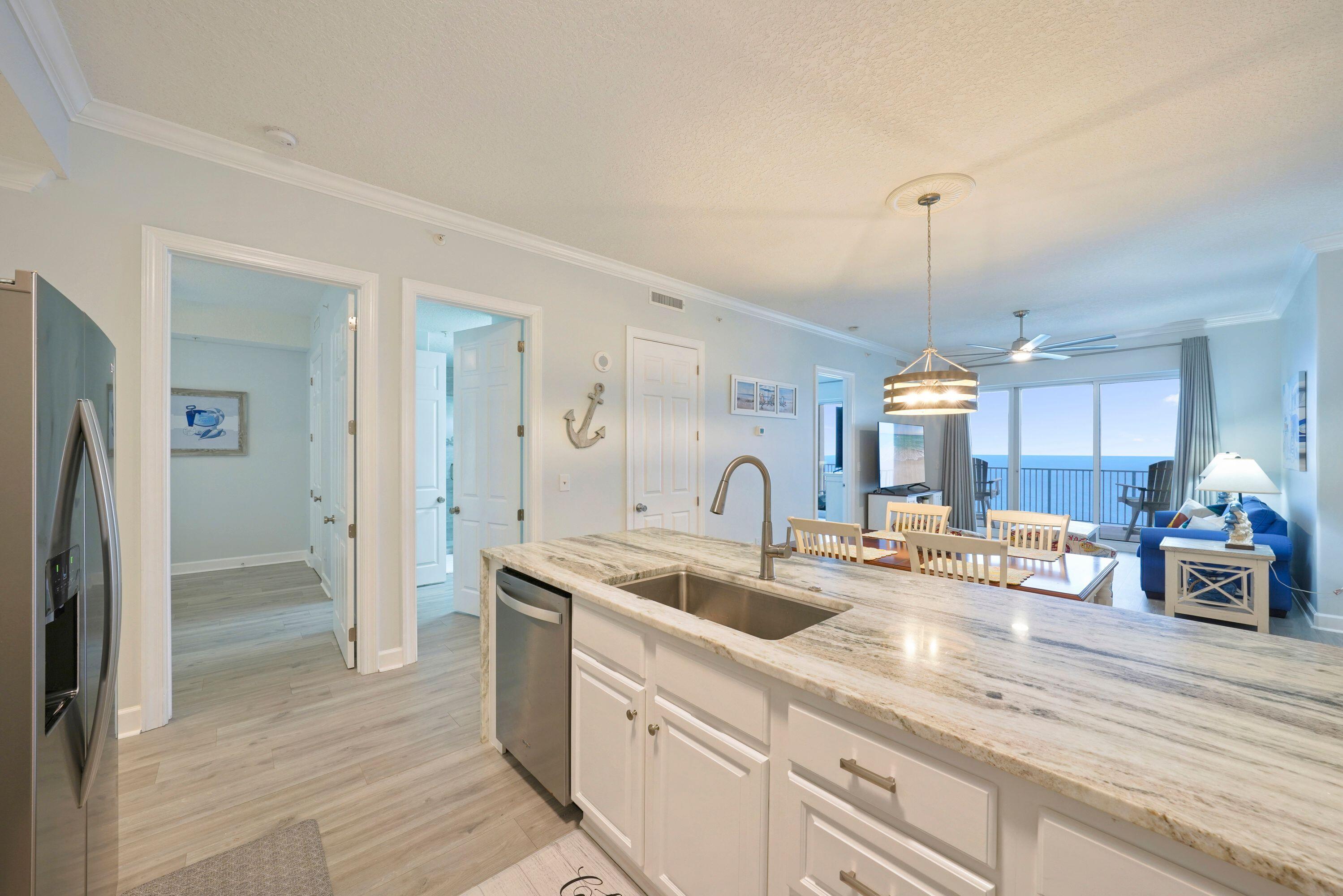 14415 Front Beach Road, Unit 2007 Panama City Beach, FL 32413 - Photo 26 of 26 a kitchen with stainless steel appliances granite countertop a sink a counter space and refrigerator