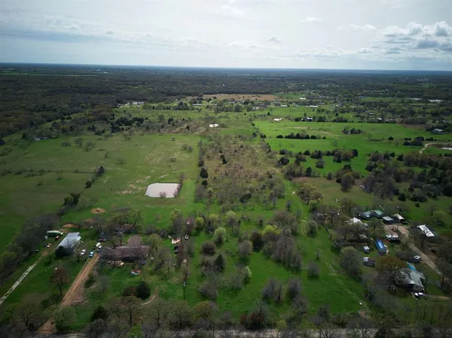 a view of a green field with lots of trees