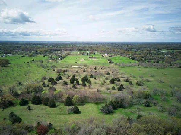 a view of a field with an ocean