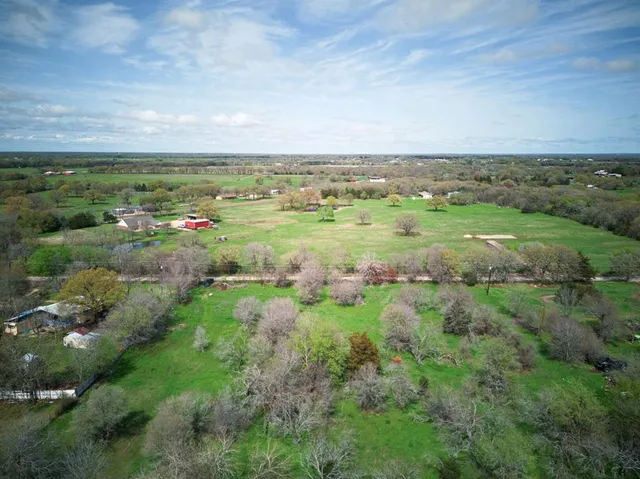 a view of a field with an ocean