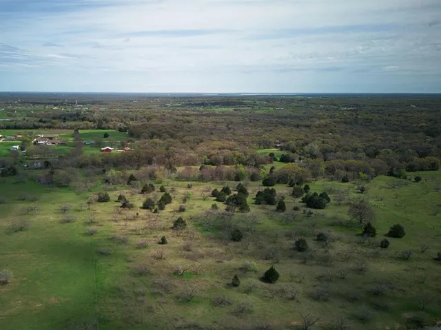 a view of a field with an ocean