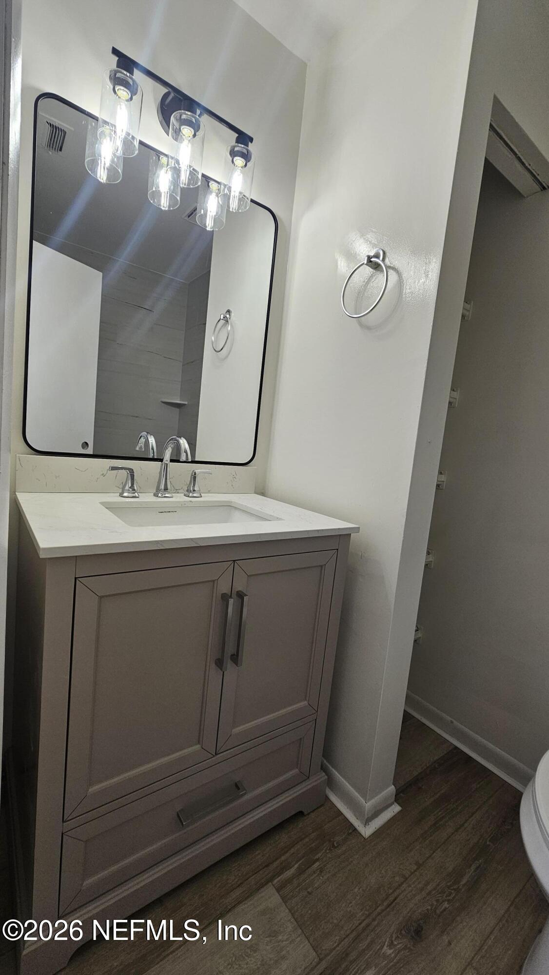 820 Orchid Street Atlantic Beach, FL 32233 - Photo 13 of 27 a bathroom with a sink a mirror and vanity