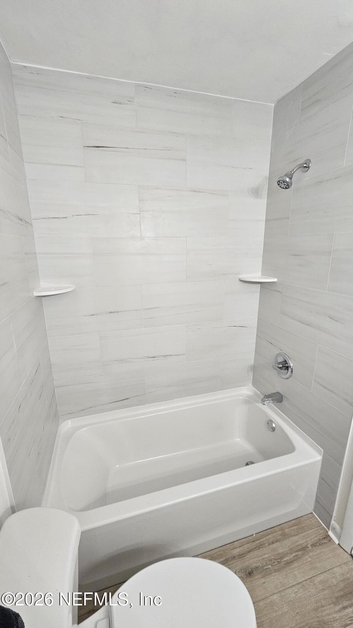 820 Orchid Street Atlantic Beach, FL 32233 - Photo 14 of 27 a bathroom with a toilet and bathtub