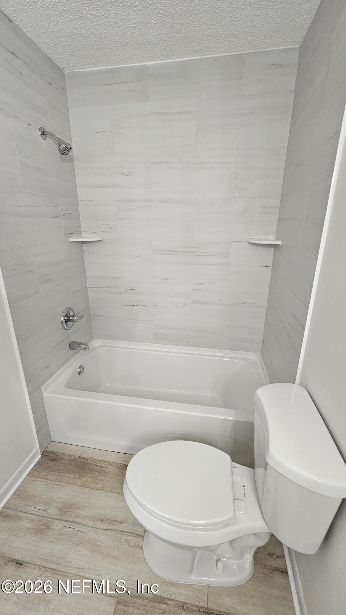 820 Orchid Street Atlantic Beach, FL 32233 - Photo 18 of 27 a bathroom with a toilet and a bathtub