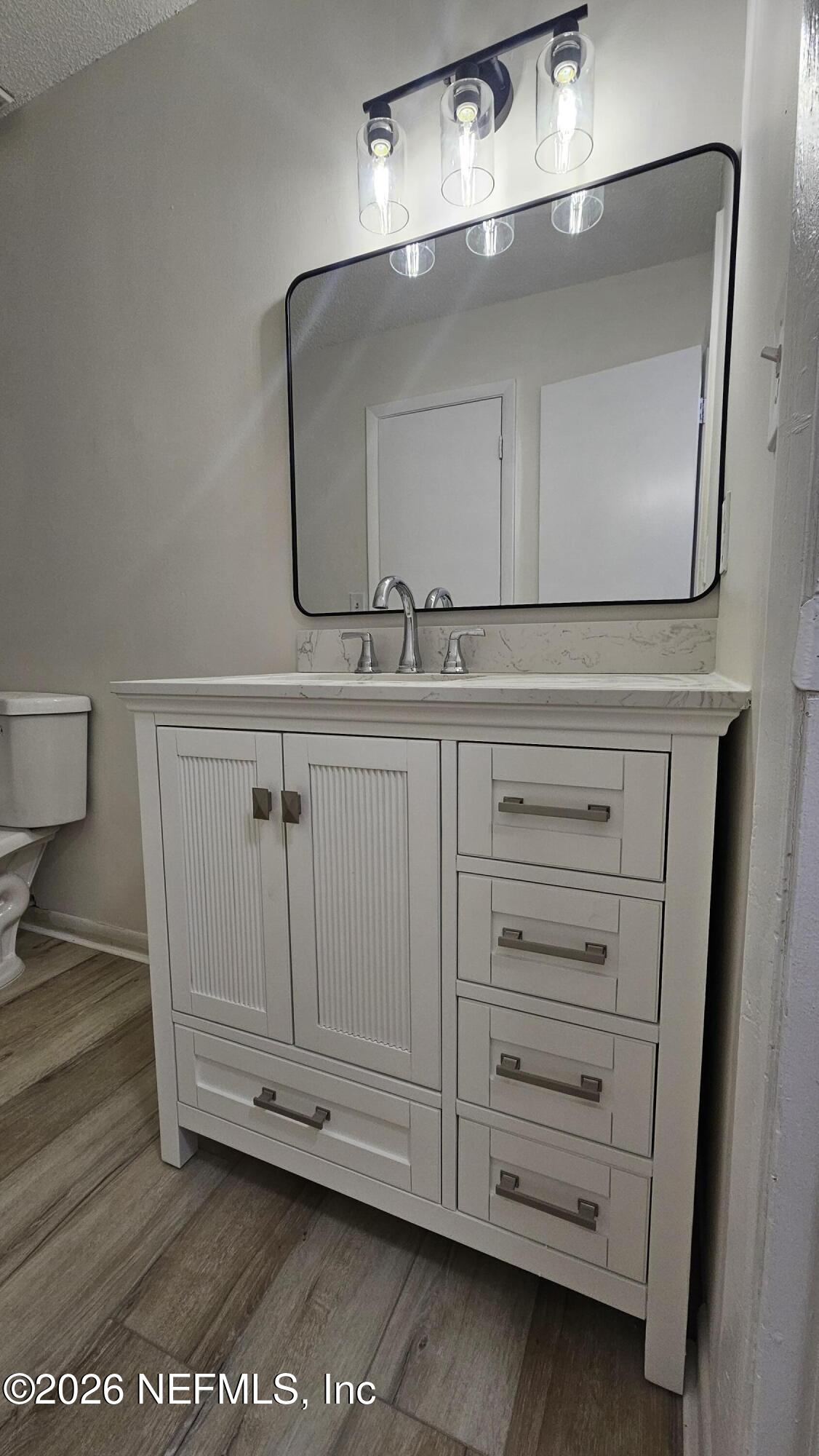 820 Orchid Street Atlantic Beach, FL 32233 - Photo 20 of 27 a bathroom with a sink a mirror and vanity