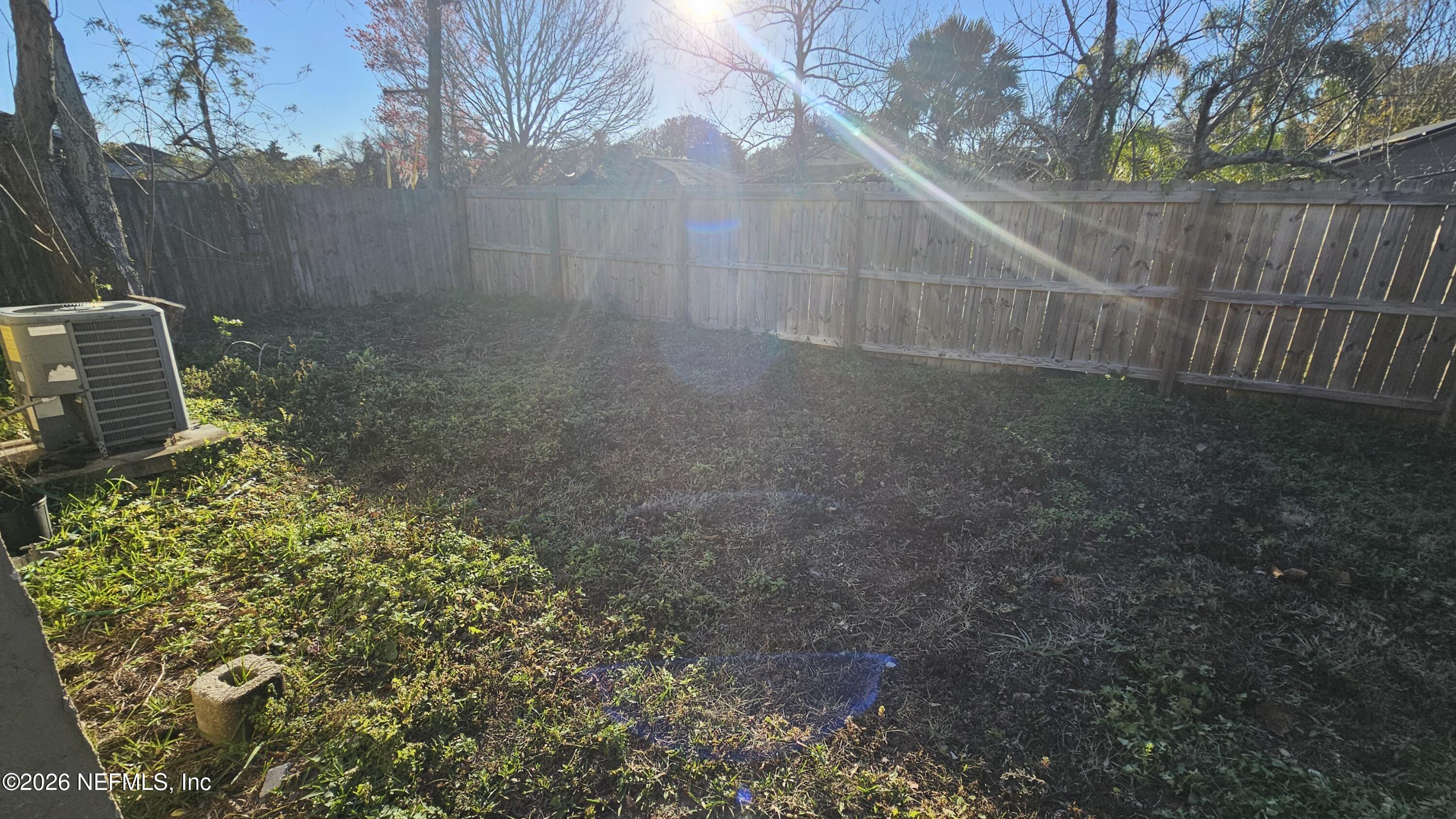 820 Orchid Street Atlantic Beach, FL 32233 - Photo 27 of 27 a view of a yard with plants and wooden fence