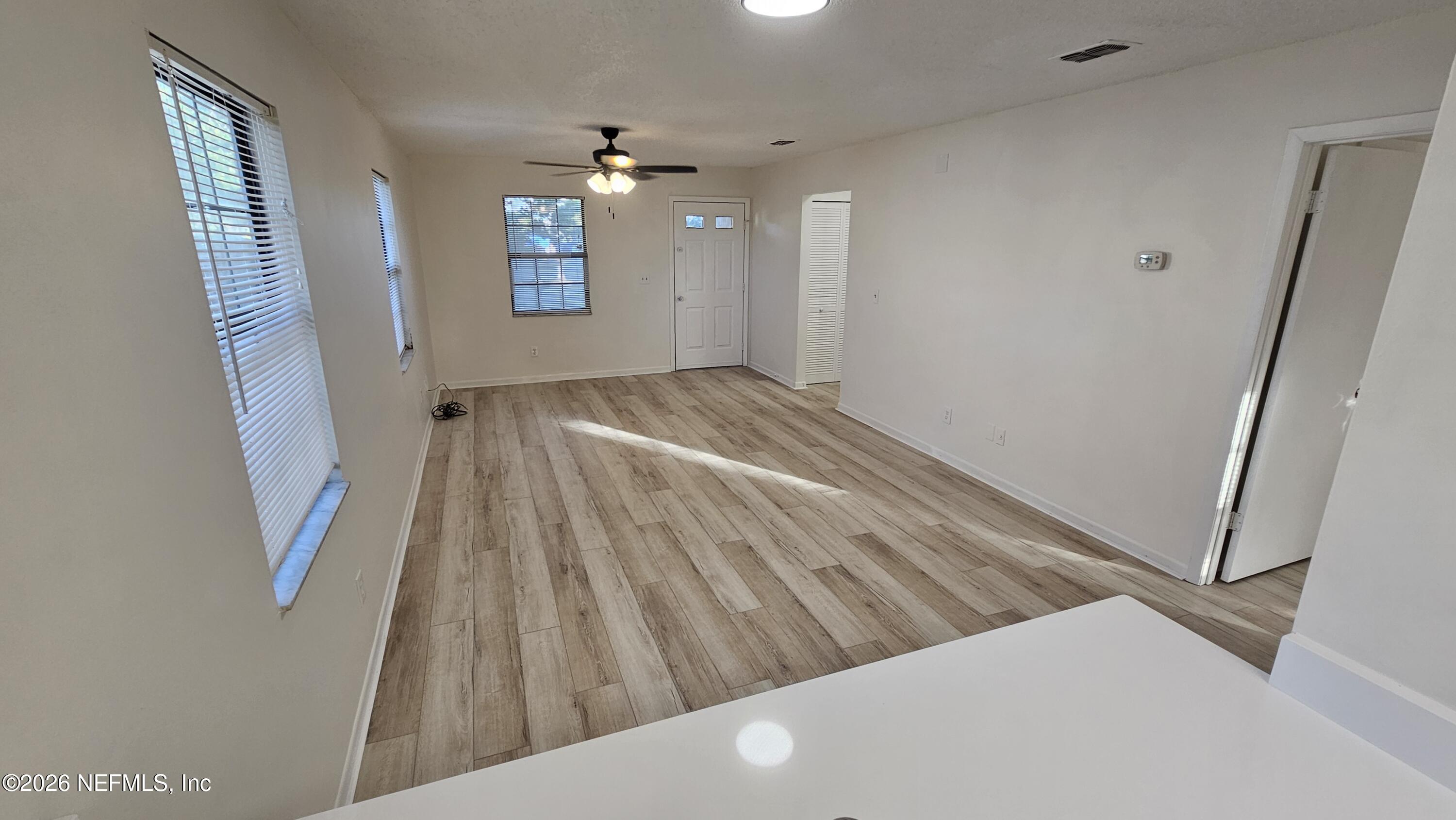 820 Orchid Street Atlantic Beach, FL 32233 - Photo 5 of 27 a view of an empty room and wooden floor
