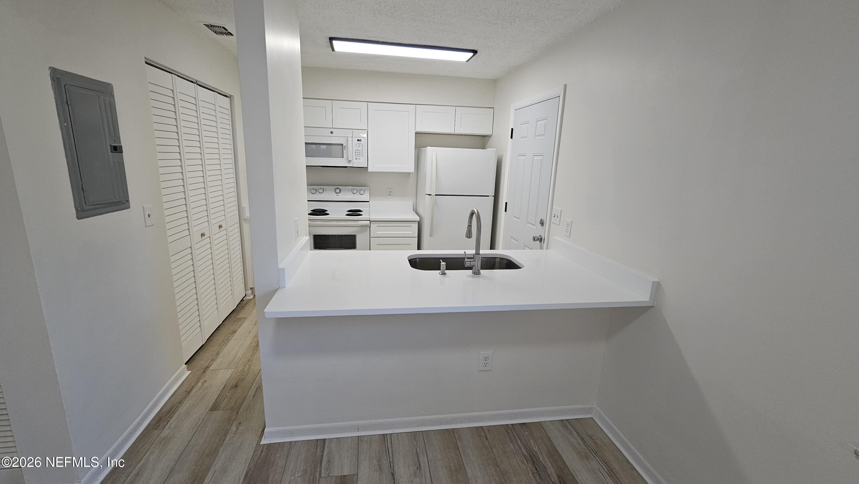 820 Orchid Street Atlantic Beach, FL 32233 - Photo 6 of 27 a view of kitchen with wooden floor