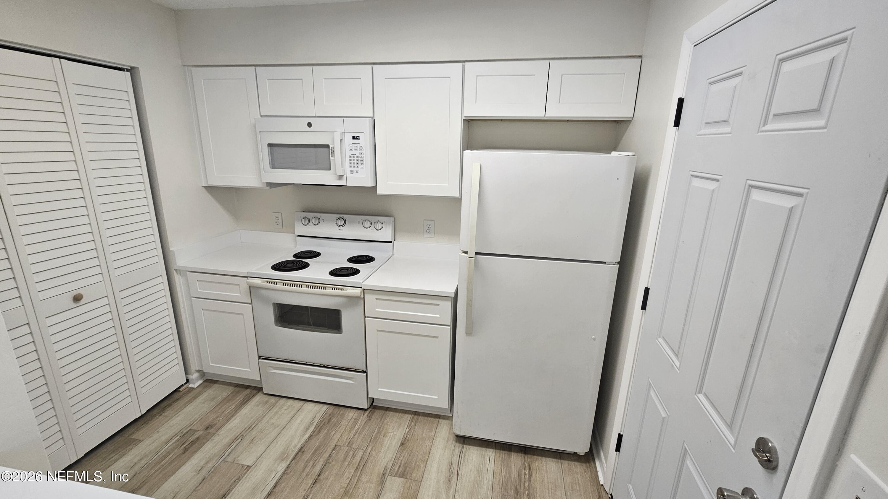 820 Orchid Street Atlantic Beach, FL 32233 - Photo 7 of 27 a white refrigerator freezer sitting inside of a kitchen
