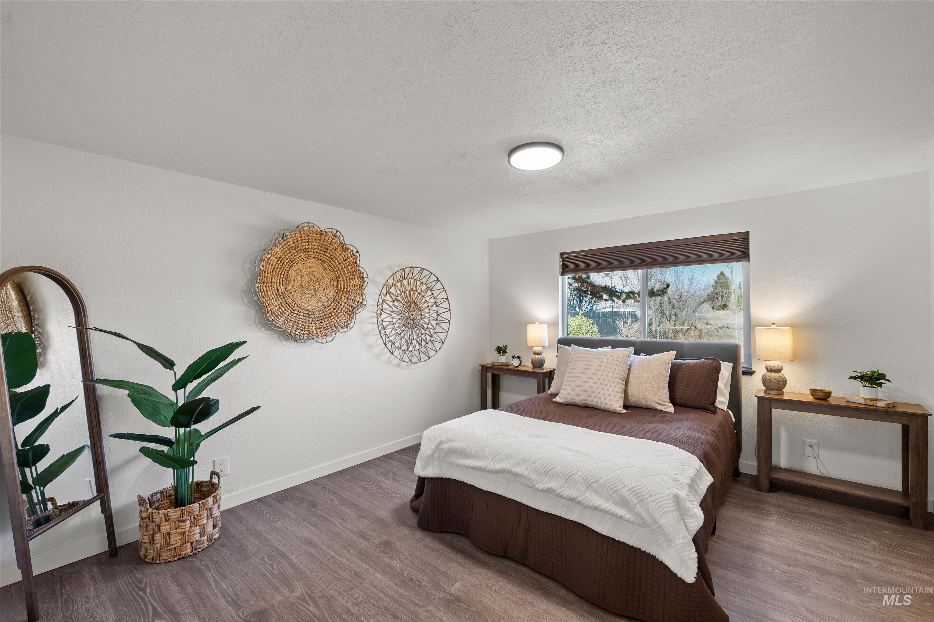 3154 South McCormick Way Boise, ID 83709 - Photo 10 of 50 Bedroom with wood finished floors and a textured ceiling