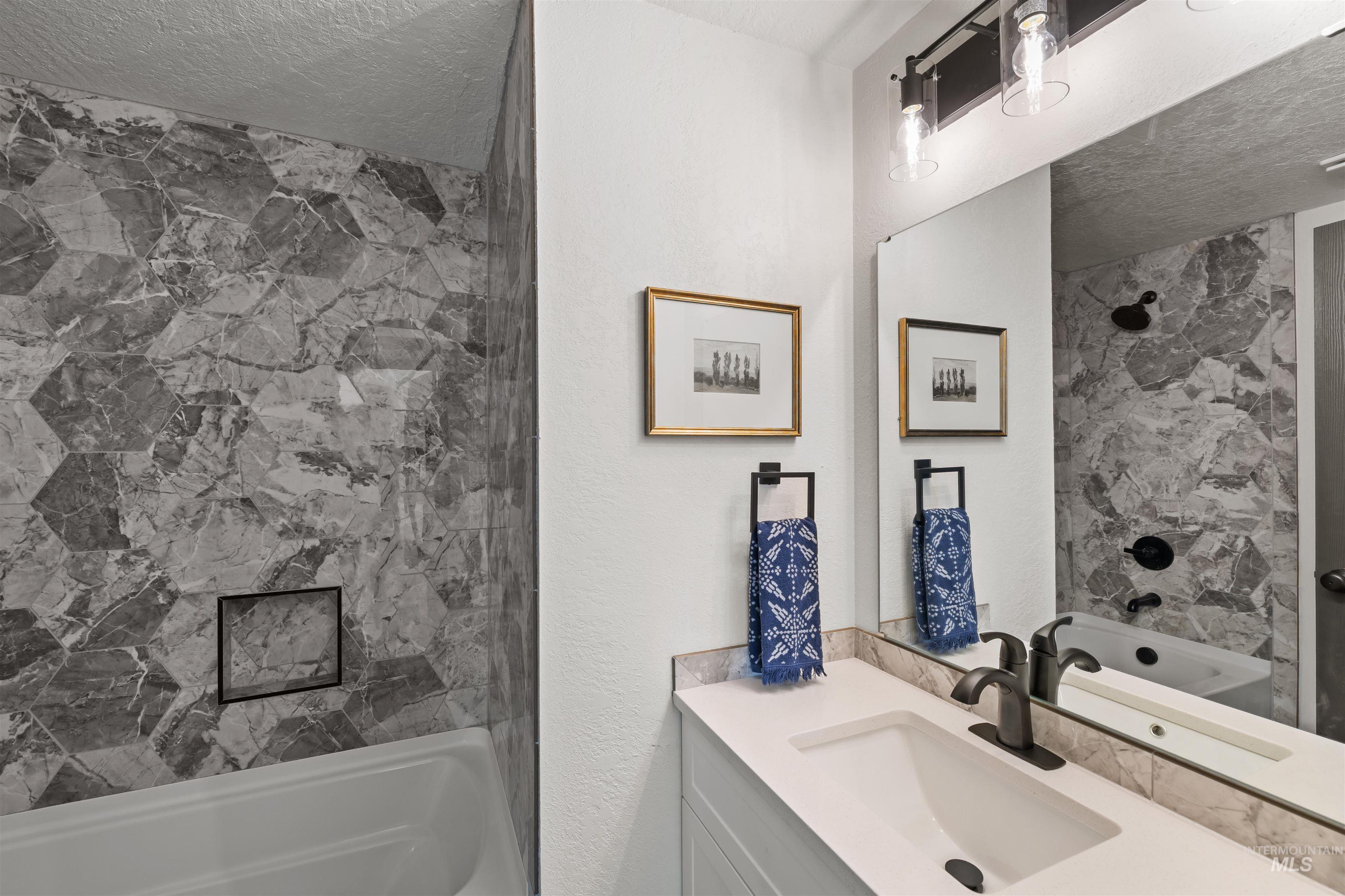 3154 South McCormick Way Boise, ID 83709 - Photo 17 of 50 Bathroom featuring shower combination, a textured ceiling, and vanity