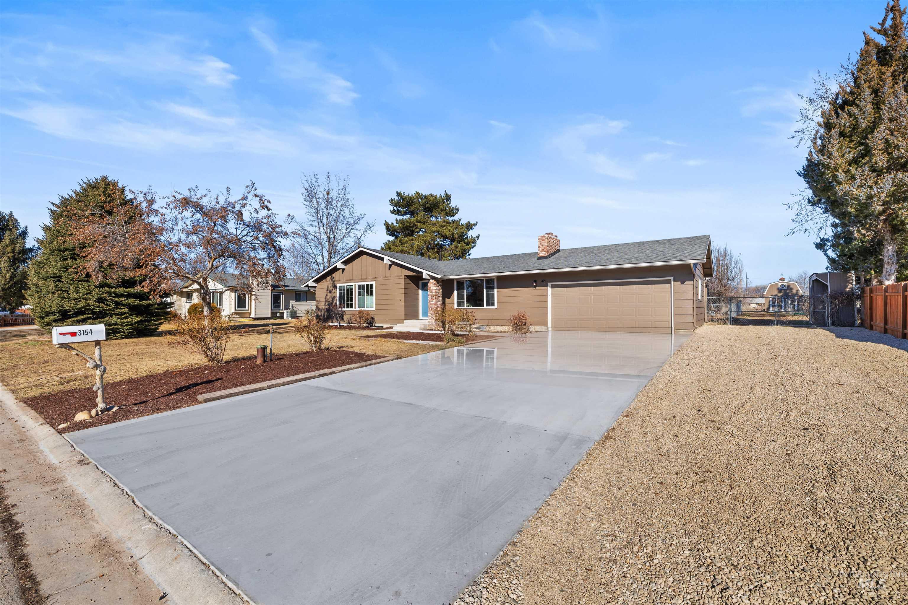 3154 South McCormick Way Boise, ID 83709 - Photo 2 of 50 Ranch-style home featuring a chimney, concrete driveway, and a garage