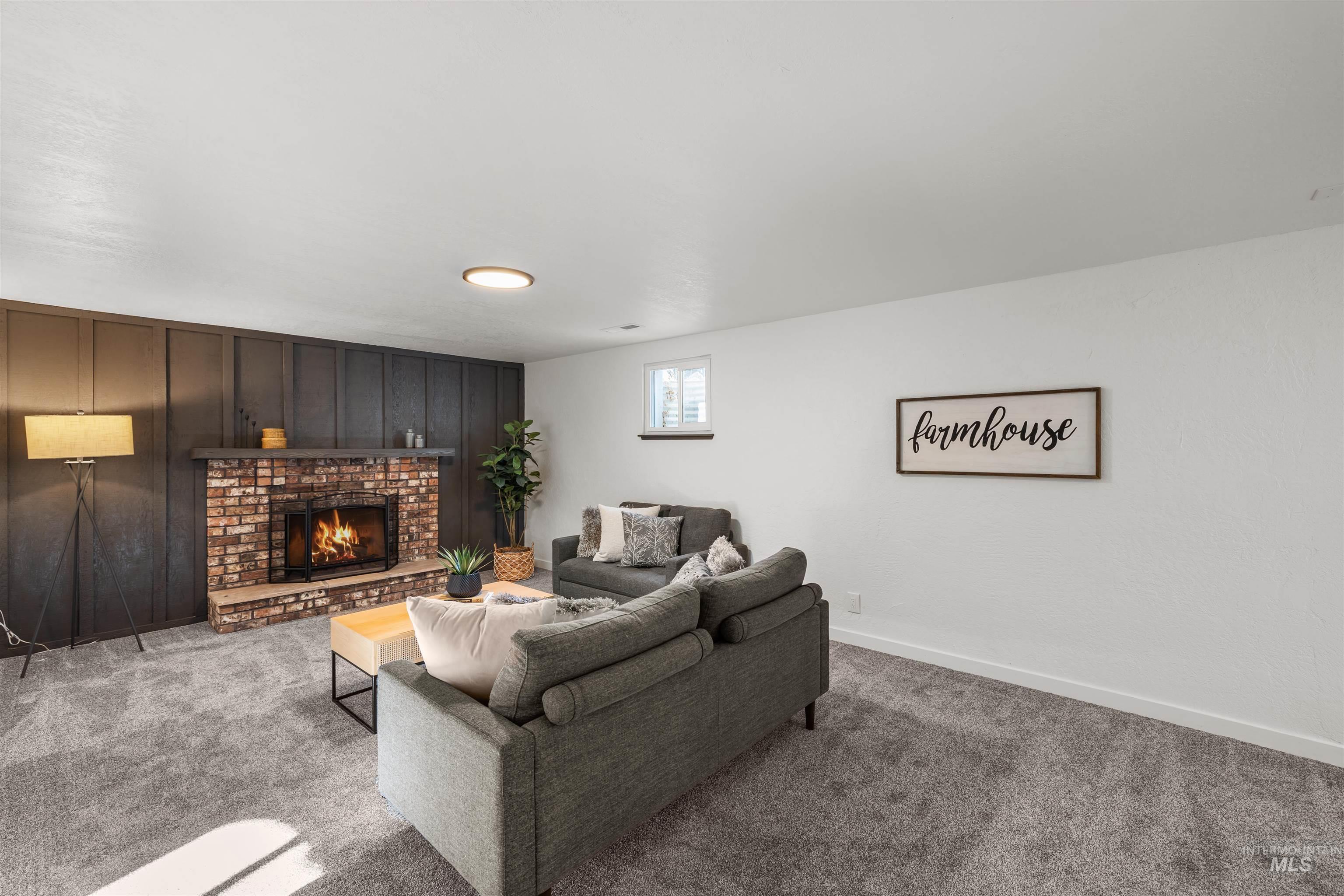 3154 South McCormick Way Boise, ID 83709 - Photo 22 of 50 Carpeted living area featuring a fireplace and wood walls